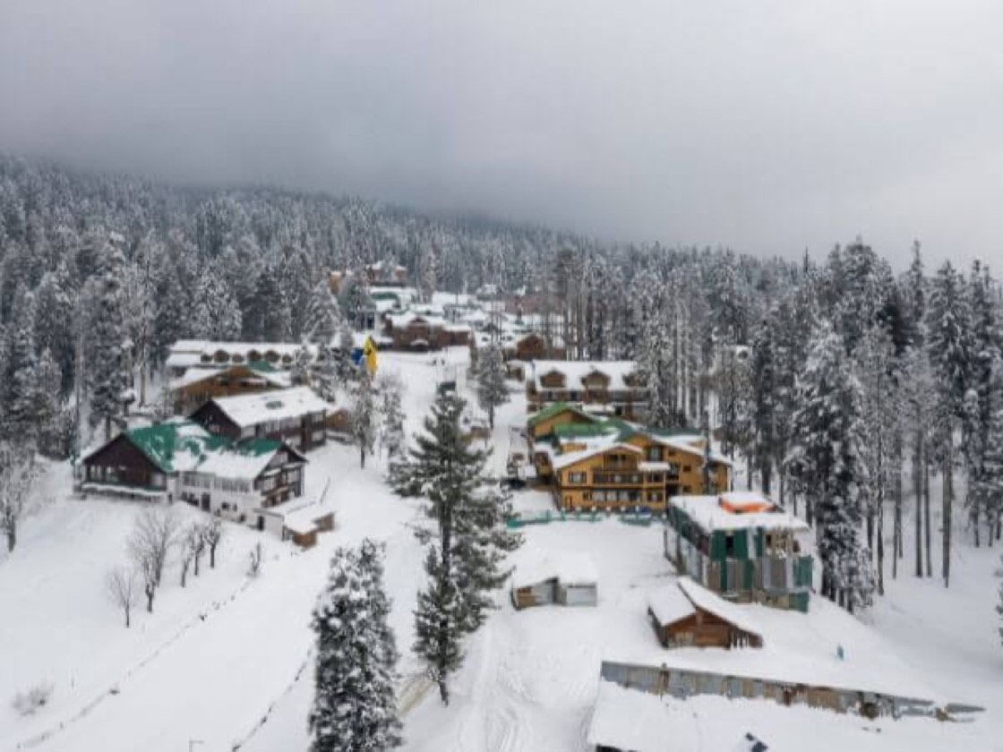 Snow-covered Gulmarg village and pine forest